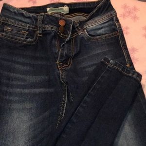 Dark wash blue skinny jeans.